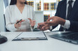 © Kritdanai - Legal Counsel Consultation:  A focused discussion between a male and female lawyer and client, reviewing legal documents.  The image conveys professionalism, trust, and legal expertise.