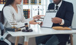 © Wicitr - Legal Consultation:  A lawyer and client review documents together, showcasing trust and collaboration in a professional legal setting.