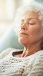 © red_orange_stock - An elderly woman enjoys a peaceful nap on her inviting couch, surrounded by home comforts and gentle sunlight