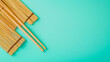 © kudesniza - Bamboo chopsticks and mats on a turquoise background for dining and decor