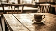 © Naree - A steaming cup of coffee rests on a rustic wooden table in a cozy cafe setting.