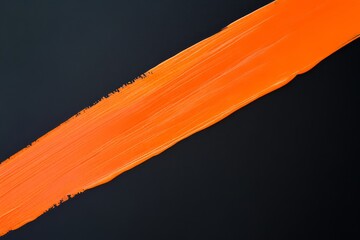 Wall Mural - An ultra-realistic photo of a thick orange stripe of paint on a black background