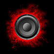 © vallerato - Audio speaker with bright red cracks on a black background. Copy space. Device for playing music. Musical