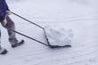 © Po - The process of snow removal by road services from pedestrian areas and sidewalks. Winter work processes, seasonal expenses in the city budget, troubles from natural precipitation