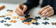© DOUGLAS - focused individual assembling colorful jigsaw puzzle on white table, showcasing concentration and problem solving skills