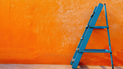 blue ladder in front of orange wall