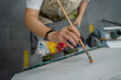 © Jorge - Artist starts painting on canvas at art workshop