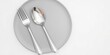 © PuriStudio - Shiny flatware set displayed on a vibrant green background, utensils, flat lay, kitchen