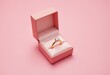 © Giuseppe Cammino - A pink gift box and engagement gold ring with diamond on pink pastel background. Wedding, romantic concept. Jewelry. The concept of marriage or anniversary