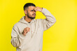 © Andrii Iemelianenko - Exhausted tired Indian young man takes off glasses, feels eyes pain, being overwork burnout from long hours working. Sleepy exhausted Arabian guy rubbing eyes isolated on studio yellow background