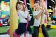 © Studio Peace - Happy children, a boy and a girl, are riding a carousel in a modern playroom.