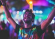© Surachetsh - The man smile and dynamic expressions showcase the energy of an outdoor event with LED lit buildings behind him.