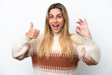 Wall Mural - Young caucasian woman isolated on white background showing ok sign and thumb up gesture