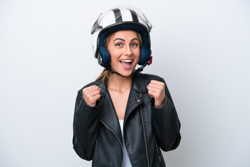 Wall Mural - Young caucasian woman with a motorcycle helmet isolated on white background celebrating a victory in winner position