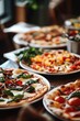 © Ева Поликарпова - A table filled with multiple pizzas featuring different toppings