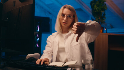 Tired overworked woman Caucasian female girl businesswoman business developer programmer coder home night online work stock market web crypto trading computer e-commerce show thumb down sad bad result