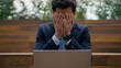 © Yuliia - Caucasian businessman guy male entrepreneur remote work using pc laptop outdoors frustrated sad anxious stressed business man computer error crash breakdown tech problem failure scam bad news in city
