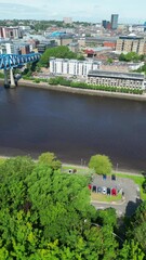 Wall Mural - Central Newcastle City from River Tyne at Northern England United Kingdom. July 19th, 2024, High Angle Drone's Camera Footage Was Captured from Medium High Altitude.