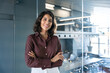 © Stock 4 You - Portrait of beautiful successful hispanic young business woman with crossed arms smiling at camera. Latin or eastern confident middle age female ceo leader businesswoman standing in office. Copy space