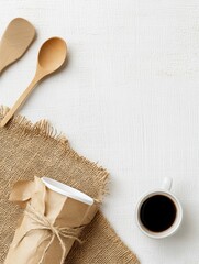 Aufkleber - A warm morning atmosphere featuring a cup of coffee, wrapped takeaway cup, and wooden spoons on a rustic burlap mat. Generative AI