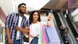 © Prostock-studio - Shopping Together. Happy Black Woman Pointing Finger Showing Something To Her Boyfriend While Walking In Mall