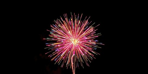 colorful explosions of light and sound from a spherical firework exploding in mid-air, bright lights