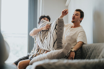 Wall Mural - Two friends enjoy a cheerful pillow fight, sharing laughter and bonding in a cozy living room setting.