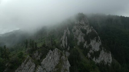Wall Mural - Aerial footage of morning fog covering rocky mountains in slovakia