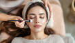 © Pawsitive Vibes - A beautiful woman receiving a facial treatment at a spa or beauty salon and appears to be relaxed as a beautician applies a product to her