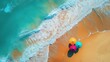 © xinxia - Beautiful beach with waves and colorful umbrellas, top view, drone shot, bright sunny day