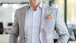 © Preecha - Close-up of a well-dressed professional in business casual attire, blurred office background, with room for text, deep depth of field