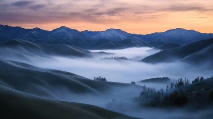 Wall Mural - A beautiful sunrise with fog rolling through the valley between mountains.