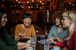 © La Famiglia - A multiracial group of people drinking coffee and bonding at the cafe