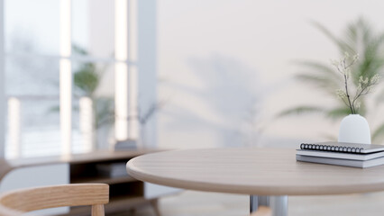 Wall Mural - A close-up of a space on a round wooden table in a minimalist white and bright living room.