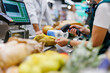 © Zamrznuti tonovi - Cashier scanning potatoes at supermarket checkout counter