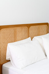 Aufkleber - Cozy bed with white pillows and wooden headboard in bright room