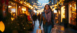 © Maria Shchipakina - Young woman carries shopping bags while walking down a festive, illuminated street. Christmas gifts shopping