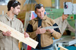 © auremar - tutor training apprentice carpenter to use woodworking implement