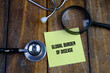 © Ardini - GLOBAL BURDEN OF DISEASE words on yellow memo pad magnifying glass and stethoscope. Medical concept.