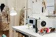 © Westend61 - Sewing machine and threads on table in design studio