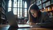 © Elena - Focused female student studying in a historic library