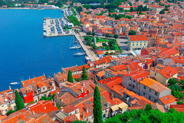 Wall Mural - Aerial view of Rovinj, a picturesque coastal town in Croatia. Dense cluster of terracotta-roofed buildings, narrow streets, and a prominent waterfront lined with boats and yachts