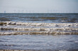 © Simon - The tide rolling in at Central Beach, Prestatyn, North Wales, UK. A line of wind turbines (offshore wind farm) on the horizon.