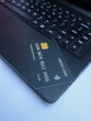 © Pratama - Close-up image of a credit card on a black keyboard, showcasing technology, finance, and payment processing