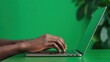 © Panisara - Green energy portfolio. Close up of hands typing on a laptop against a vibrant green background., 3D illustration