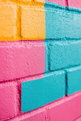 Wall Mural - a vibrant and colorful abstract wall featuring bright pink, yellow, and blue brick patterns ideal fo