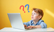 © Radorog. - a boy is sitting in front of a laptop looking for an answer to a question, there is a question mark in the air, on a yellow background