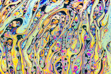 Wall Mural - Real photograph of a colorful light diffraction on a soap bubble surface with random swirls, curves and lines