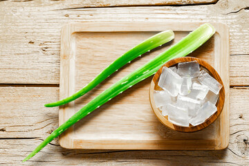 Wall Mural - aloe vera and pieces of its pulp on a wooden pit