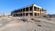 © Iona - A desolate building lies in ruins, with debris scattered, illustrating the aftermath of destruction under a stark blue sky.